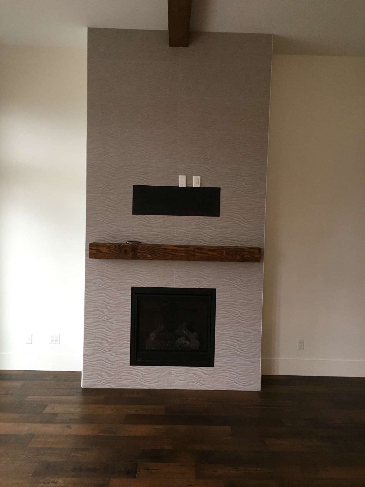 Large-format textured tile fireplace with live-edge walnut mantel